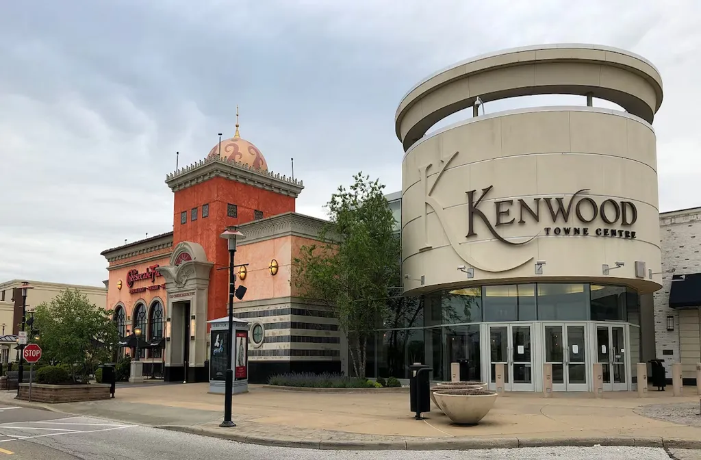 Luxury limo service in Kenwood featuring a sleek black stretch limousine parked in an upscale neighborhood with historic homes and greenery, showcasing premium transportation and comfort.