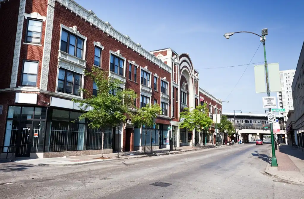 Luxury limo service in Rogers Park featuring a sleek black stretch limousine parked near a vibrant lakeside neighborhood with urban charm, showcasing premium transportation and comfort.