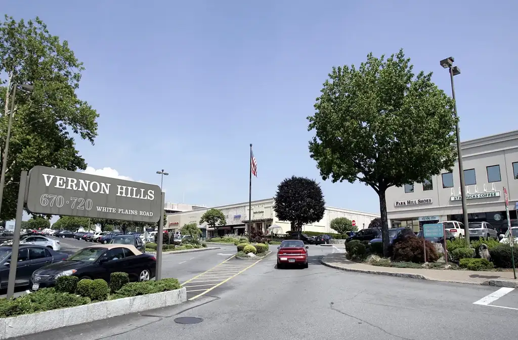 Luxury limo service in Vernon Hills with a sleek black stretch limousine parked in a modern suburban setting, highlighting premium transportation and comfort.