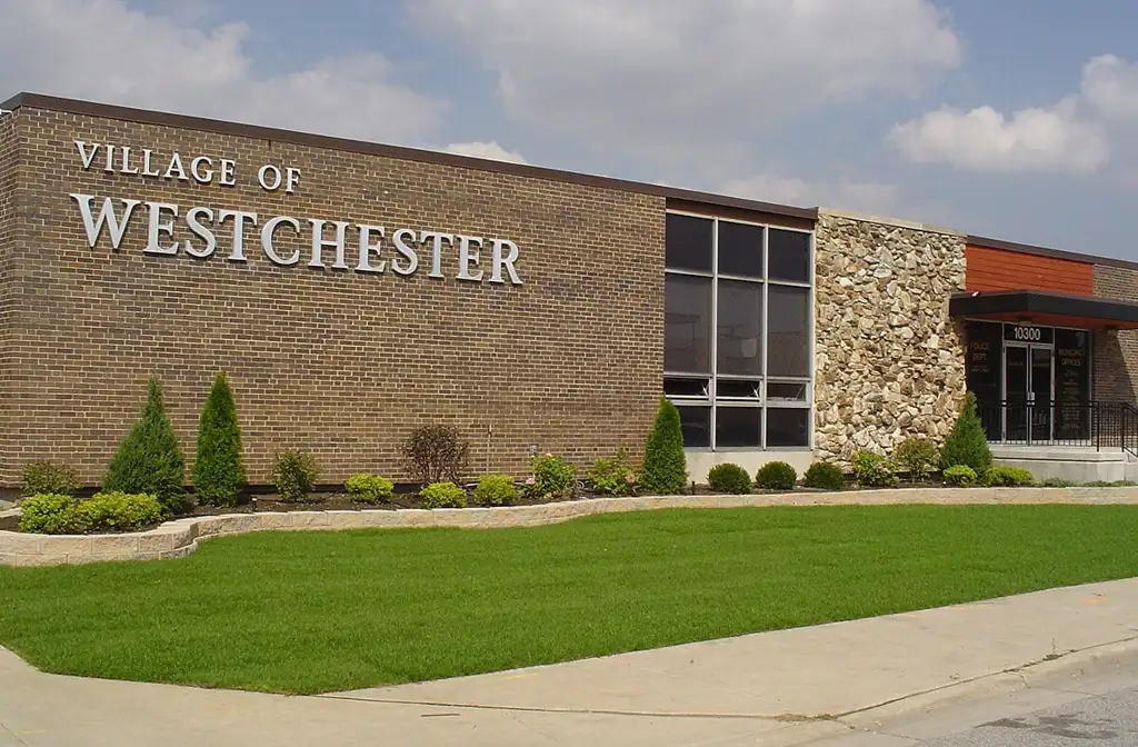 Luxury limo service in Westchester featuring a sleek black stretch limousine parked in a clean and upscale suburban neighbourhood, showcasing premium transportation and comfort.