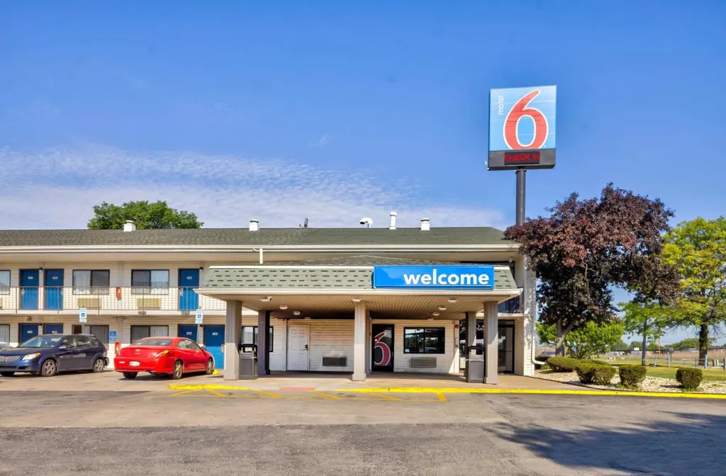 Professional car service from Chicago to Hammond featuring a sleek black sedan traveling on a smooth highway, representing reliable and comfortable long-distance transportation.