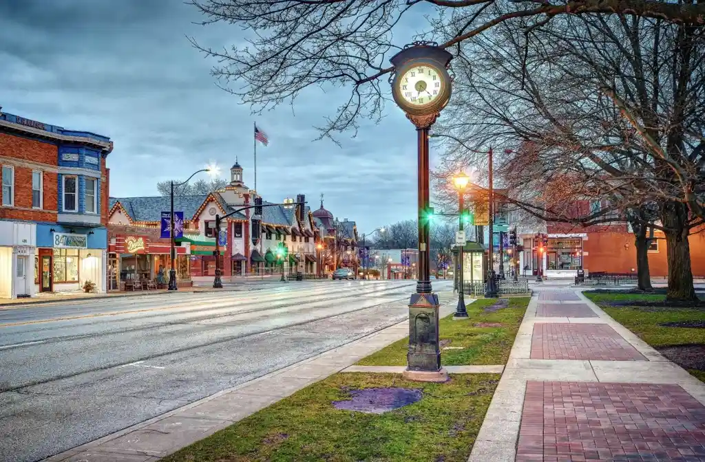 Professional limo service in Libertyville featuring a sleek black stretch limousine parked in an upscale suburban area, representing luxury transportation and reliability.